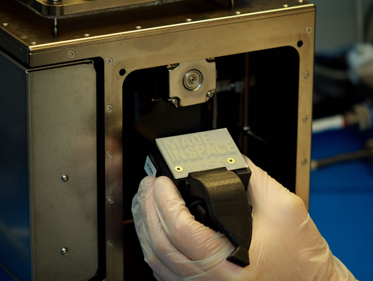 The ‘First Print’ in space is a part of the printer itself. The printhead faceplate holds internal wiring in place within the 3D printer’s extruder. (Photo courtesy of Made In Space)