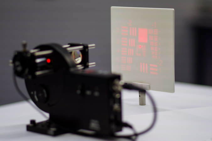 A laser beam is diffracted by a 3D-printed diffractive optical element. As a result, the precision pattern of the USAF Chart can be seen here. (Photo courtesy of Nanoscribe)