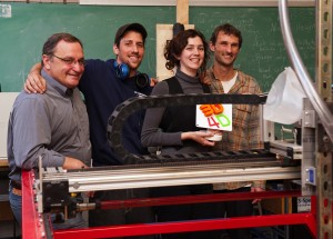 Faculty adviser Duane Storti and team members Brandon Bowman, Bethany Weeks and Matt Rogge with their trophy. In the foreground is Big Red, a giant 3-D printer that can turn plastic garbage into new objects.
