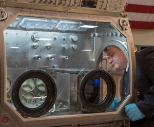 Co-PI on the 3D Printing in Zero G Experiment, and Made in Space’s Director of R&D, Michael Snyder examines the engineering unit 3D printer inside the Microgravity Science Glovebox.