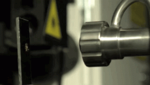Unlike traditional manufacturing, which removes material to achieve the final shape, most additive methods build parts from the ground up. This GIF captures particles leaving the cold spray nozzle at four times the speed of sound and hitting their target. The image was slowed down by using a camera capable of shooting 10,000 frames per second. (GIF credit: GE Global Research)