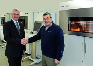 (f.l.t.r.) Stuart Jackson, Regional Manager EOS UK with Richard Brady, Advanced Digital Manufacturing Leader, in front of an EOSINT P 760 system (Photo courtesy of EOS)