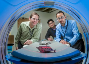 Dr. Faidi (middle) and members of his team are moving a sample inside their CT scanner. Image credit: GE Global Research