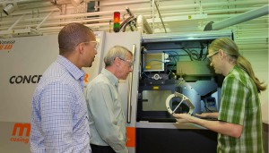 From left: Lawrence Livermore National Laboratory researchers — Ibo Matthews, a principal investigator leading the Lab’s effort on the joint open source software project; Wayne King, director of the Accelerated Certification of Additively Manufactured Metals Initiative; and Gabe Guss, engineering associate — examine a 3D-printed part manufactured using the selective laser melting process. (Photo courtesy of LLNL)