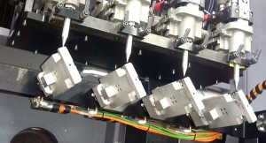The open architecture of the Aerosol Jet hardware allows configurations to be optimized for specific production needs. The implementation at LITE-ON leverages a series of Aerosol Jet print modules spread across multiple 5-axis motion platforms, configured to handle common smartphone and tablet form factors. (Photo courtesy of Optomec)