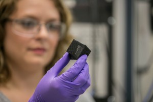 Lab researcher Jennifer Rodriguez examines a 3D printed box that was "programmed" to fold and unfold when heated. (Photo by Julie Russell/LLNL)