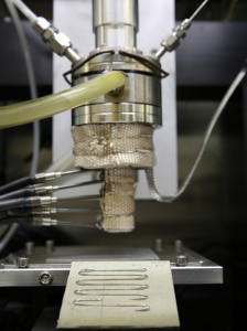 Unlike other metal 3D printing techniques that use lasers to fuse metal powder, the direct metal writing approach incorporates an ingot that is heated until it reaches a semi-solid state before it's forced through a nozzle. As it cools, the material hardens to form a 3D metal structure. (Photo by Kate Hunts/LLNL)