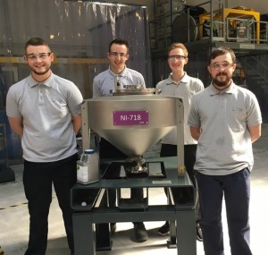 LPW past, present and future: an original powder container, the innovative PowderTrace hopper, and the 2017 apprenticeship team. (Photo courtesy of PLW Technology Ltd.)