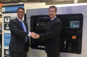 Scott Sevcik, Head of Aerospace, Defense and Automotive Solutions, Stratasys (on left) congratulates Collin Wilkerson, Managing Director, Western Tool & Mold on his company’s purchase of the Stratasys Fortus 900mc Aircraft Interiors Certification Solution (Photo: Business Wire)