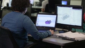 Stratasys Additive Manufacturing-certified Jazmine Darden from Dunwoody College of Technology reviews the Fabrication Considerations module – and prepares on GrabCAD Print for the Stratasys F370 3D Printer (Photo: Business Wire)